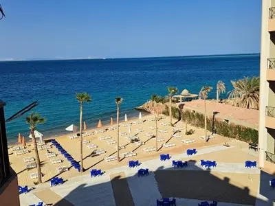 an aerial view of a beach with chairs and the ocean at Hotel apartment with a private beach in Hurghada