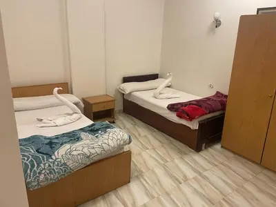 a room with two beds in a room at Eye of Horus House in Luxor