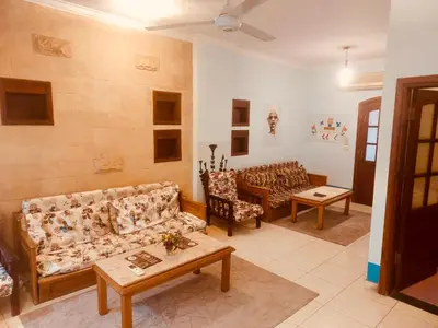 a living room with couches and a table at Eye of Horus House in Luxor