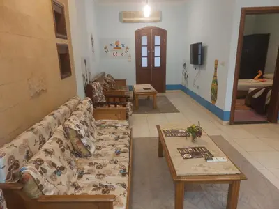 a living room with a couch and a table at Eye of Horus House in Luxor