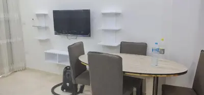 a room with a table with chairs and a television at Hurghada celina branch & resort in Hurghada
