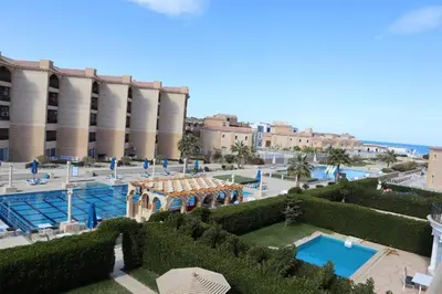 a view of a garden with a pool and a building at Hurghada celina branch & resort in Hurghada