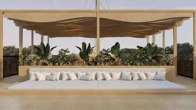 a large white couch in a room with plants at Nefertem Yacht, All-Inclusive Boutique Charter in Luxor