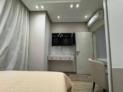a bedroom with a bed and a tv on the wall at Luxury Villa Hurghada Pool Near Senzo Mall 3story in Hurghada