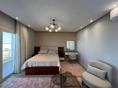 a bedroom with a bed and a chair and a mirror at Luxury Villa Hurghada Pool Near Senzo Mall 3story in Hurghada