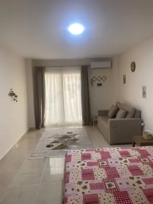 a living room with a couch and a rug at Tiba Golden Resort in Hurghada