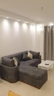 a living room with a couch and a table at Florenza khamsin Apartment in Hurghada