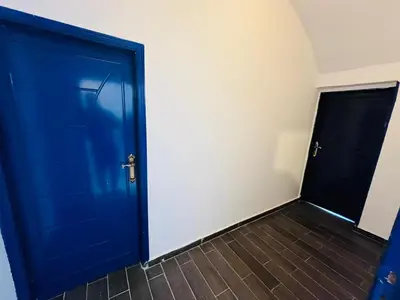 a blue door in a room with a tile floor at Sharqotel Luxor in Luxor