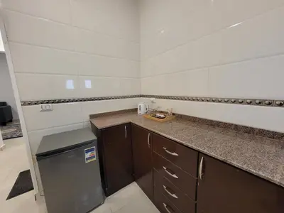 a small kitchen with a counter and a refrigerator at Sharqotel Luxor in Luxor