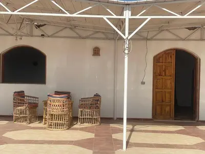 a room with three baskets and a wooden door at Nile Temple view in Luxor