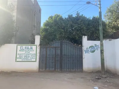a gate in a fence with a sign on it at Nile Temple view in Luxor