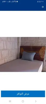 a picture of a bed with a pillow on it at Hashem Nubian Guest House in Aswan