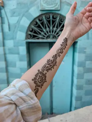 a man with a henna tattoo on his arm at Hashem Nubian Guest House in Aswan