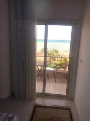 a room with a window with a view of the ocean at sea front apartment in Hurghada