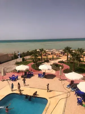 a resort with a swimming pool and a beach at sea front apartment in Hurghada