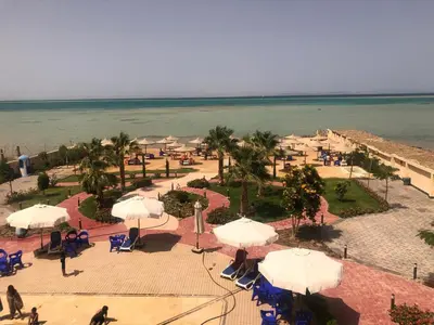 an aerial view of a resort with umbrellas and the ocean at sea front apartment in Hurghada