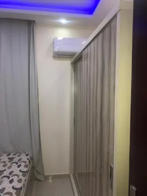 a bedroom with a bed and a window with a ceiling at sea front apartment in Hurghada