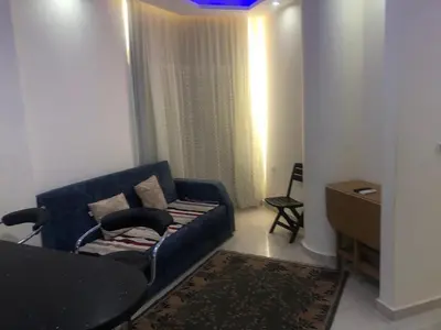 a living room with a blue couch and a table at sea front apartment in Hurghada