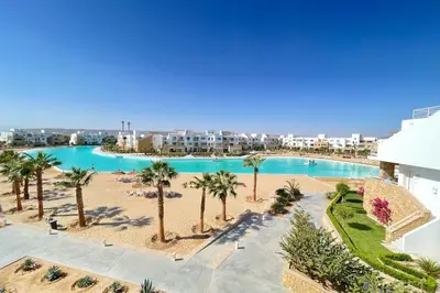 an overhead view of a swimming pool with palm trees at Lofty & Lavish 3 BDR Swan Lake El Gouna in Hurghada