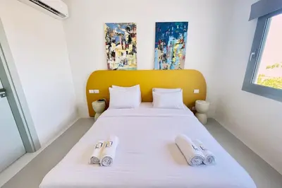 a bedroom with a bed with two slippers on it at Lofty & Lavish 3 BDR Swan Lake El Gouna in Hurghada