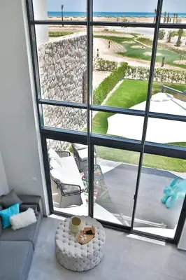 a living room with a view of a large window at Beachfront Spacious Somabay Loft in Hurghada