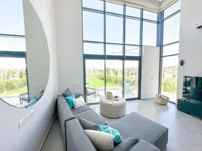 a living room with a couch and a large window at Beachfront Spacious Somabay Loft in Hurghada