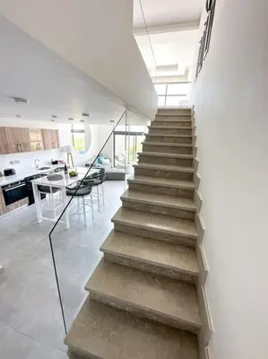 a staircase leading to a living room and a kitchen at Beachfront Spacious Somabay Loft in Hurghada