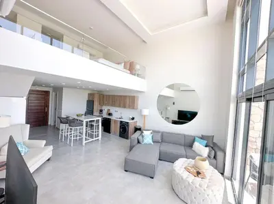 a living room with a couch and a table at Beachfront Spacious Somabay Loft in Hurghada