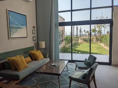 a living room with a couch and a table at Modern Beachfront 1BR Loft with Garden in Somabay in Hurghada
