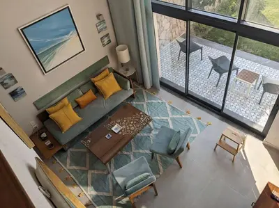 an overhead view of a living room with a couch and chairs at Modern Beachfront 1BR Loft with Garden in Somabay in Hurghada