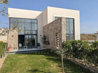 a house with a large window and a yard at Modern Beachfront 1BR Loft with Garden in Somabay in Hurghada