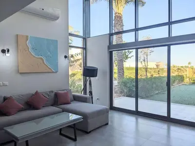 a living room with a couch and a large window at Somabay Seaview 1BR Loft 2 Mins to Beach & Pool in Hurghada