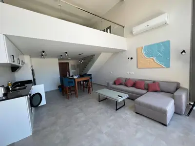 a living room with a couch and a table at Somabay Seaview 1BR Loft 2 Mins to Beach & Pool in Hurghada