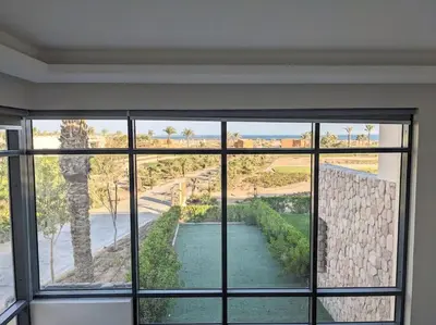 a room with a window with a view of a road at Somabay Seaview 1BR Loft 2 Mins to Beach & Pool in Hurghada