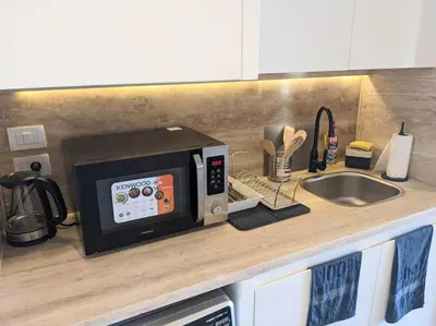 a microwave oven sitting on a kitchen counter at Magical Cabana Steps From Beach & Pool in Hurghada