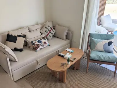 a living room with a couch and a table and a chair at Magical Cabana Steps From Beach & Pool in Hurghada