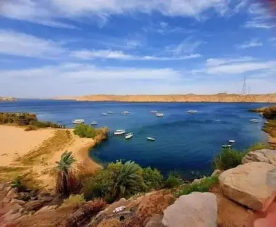 a large body of water with boats in it at البيت النوبى Nubian house in Aswân Reservoir Colony