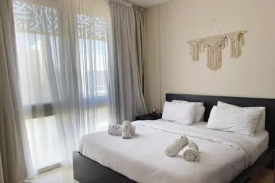 a bedroom with two beds with towels on them at Minimal & Mere 1 BDR Mangroovy Free Beach & Pool in Hurghada