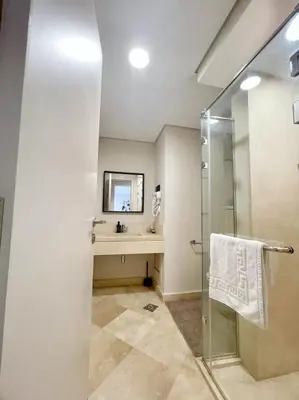 a bathroom with a sink and a shower at Minimal & Mere 1 BDR Mangroovy Free Beach & Pool in Hurghada