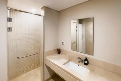 a bathroom with a sink and a shower at Scenic Pool Front 1 BDR Mangroovy Free Pool & Beach in Hurghada