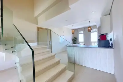 a staircase in a house with a kitchen and a counter at Embellished 2BDR Penthouse Mangroovy Free Pool & Beach in Hurghada