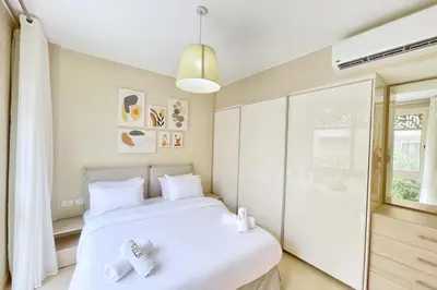 a bedroom with a white bed and a window at Peaceful & Placid 1 BDR Mangroovy Free Pool & Beach in Hurghada