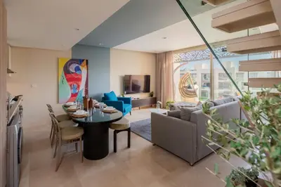 a living room with a table and a couch at Vogue & Idyllic 2 BDR Mangroovy Free Pool & Beach Access in Hurghada