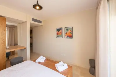 a hotel room with a bed and a desk at Vogue & Idyllic 2 BDR Mangroovy Free Pool & Beach Access in Hurghada