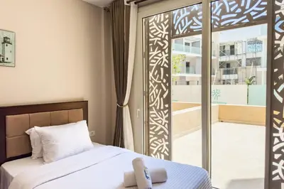 a bedroom with a bed and a sliding glass door at Staggering & Soothing 2 BDR w Pool View Free Pool & Beach Access in Hurghada