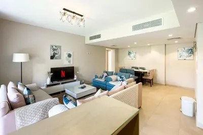 a living room with couches and a tv at Staggering & Soothing 2 BDR w Pool View Free Pool & Beach Access in Hurghada