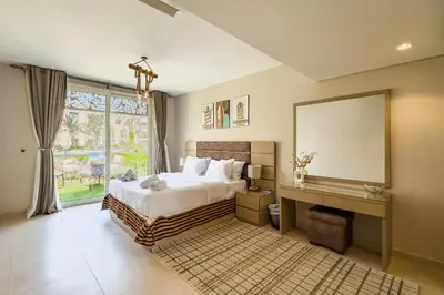 a bedroom with a large bed and a large mirror at Staggering & Soothing 2 BDR w Pool View Free Pool & Beach Access in Hurghada