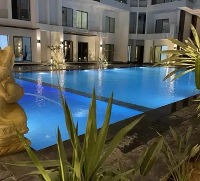 a large swimming pool with blue water in a building at Imperial Beach Resort in Hurghada