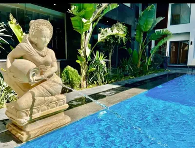 a statue sitting next to a swimming pool at Imperial Beach Resort in Hurghada