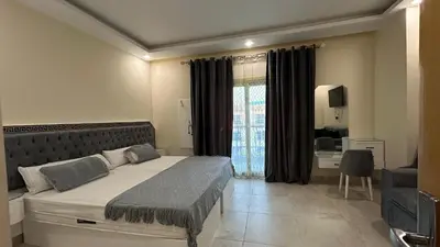 a bedroom with a bed and a desk and a window at hotel mirage aqua park in Hurghada